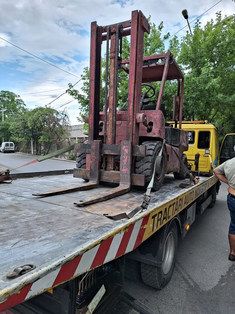Stivuitor ancorat cu chingi pe platformă pentru transport